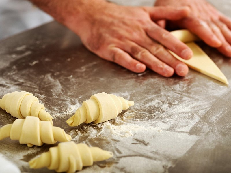 Croissant dough being rolled on the bench of a Montmartre bakery