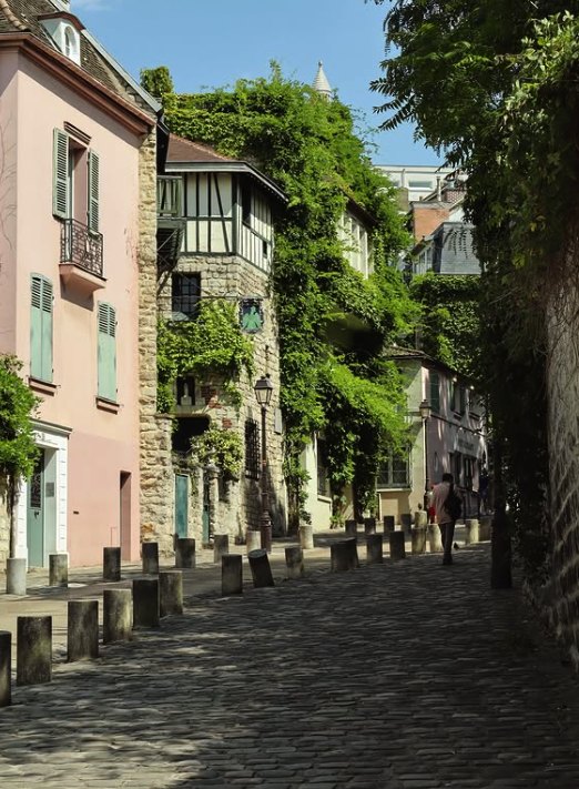 A stepped Montmartre lane between pink houses and hanging ivy